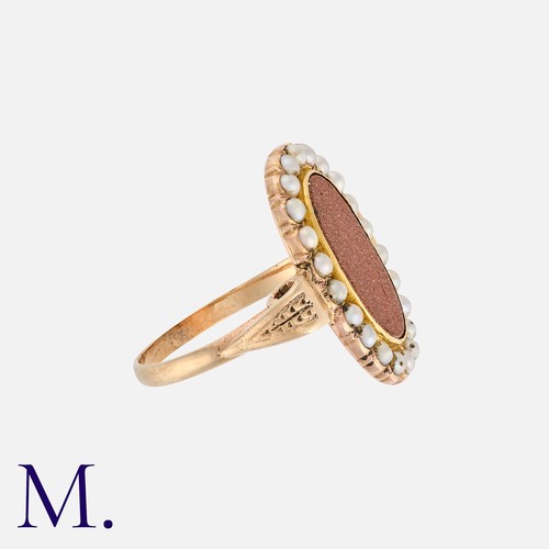 208 - A Goldstone and Pearl Ring in yellow gold, set with an oval plaque of goldstone with pearls in surro... 