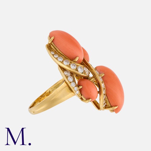 95 - A Vintage Coral And Diamond Ring in 18k yellow gold, the abstract form set with four polished coral ... 