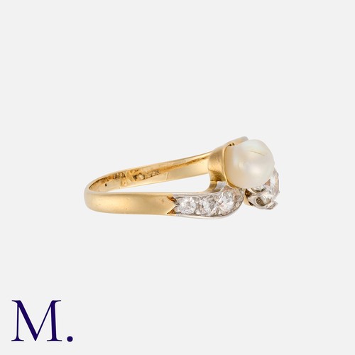 153 - A Pearl And Diamond Toi Et Moi Ring in yellow gold, in crossover design, set with a round cut diamon... 