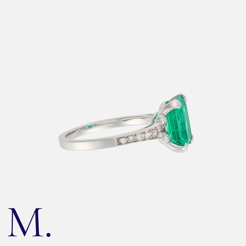 76 - A Colombian Emerald And Diamond Ring in platinum, set principally with an octagonal cut emerald of 2... 