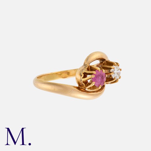 123 - A Ruby And Diamond Toi Et Moi Ring in yellow gold, of crossover design, set with a diamond of approx... 