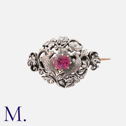 57 - An Art Nouveau Brooch in silver, set with a principal ruby of approximately 1.00cts, within an ornat... 