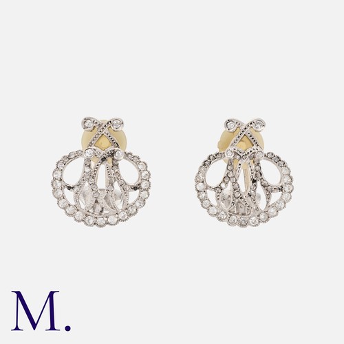 126 - A Pair Of Diamond Earrings in platinum, each of openwork form with the initial 'M', Clip back fittin... 