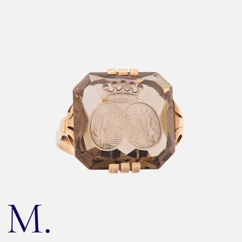 221 - An Intaglio Signet Ring in rose gold, set with a cut-cornered square smoky quartz with intaglio doub... 