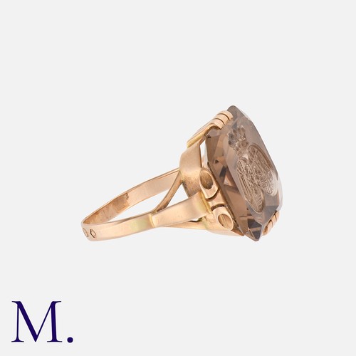 221 - An Intaglio Signet Ring in rose gold, set with a cut-cornered square smoky quartz with intaglio doub... 