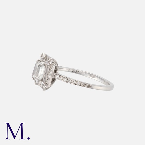 143 - A Diamond Ring in 18k white gold, set centrally with an emerald cut diamond of 0.78cts (G colour), w... 