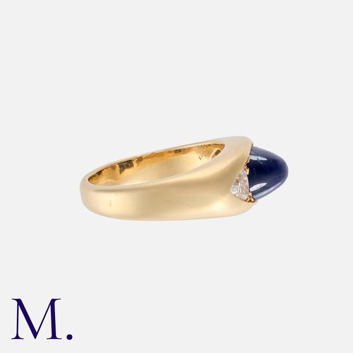 166 - A Sapphire And Diamond Gypsy Ring in yellow gold, set centrally with a principal tall cabochon sapph... 