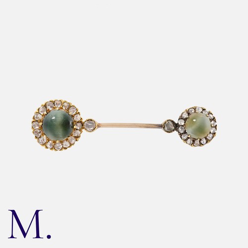 19 - An Antique Cats Eye Chrysoberyl And Diamond Brooch in yellow gold, comprising two cabochon cats eye ... 