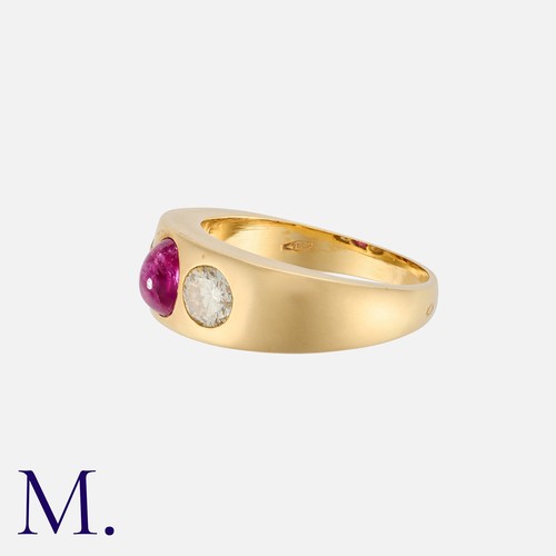 183 - A Ruby And Diamond Three Stone Gypsy Ring in 18k yellow gold, set centrally with a cabochon ruby, fl... 