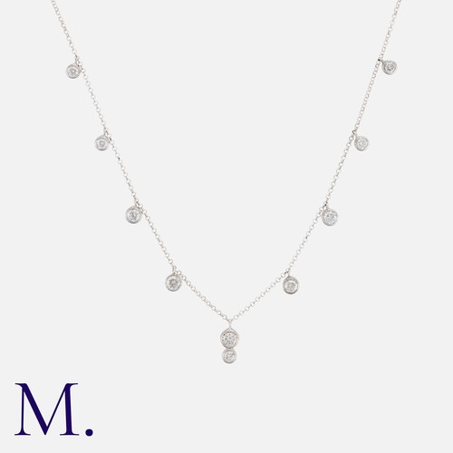 39 - A Diamond Necklace in 18k white gold, the fine chain punctuated by round cut diamond drops, diamonds... 