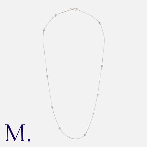 57 - A Diamond Set Necklace in 18k white gold, comprising a fine chain, punctuated by round cut diamonds ... 