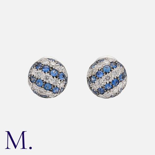 77 - A Pair of Sapphire and Diamond Earrings in white gold, in a circular dome style set with alternating... 