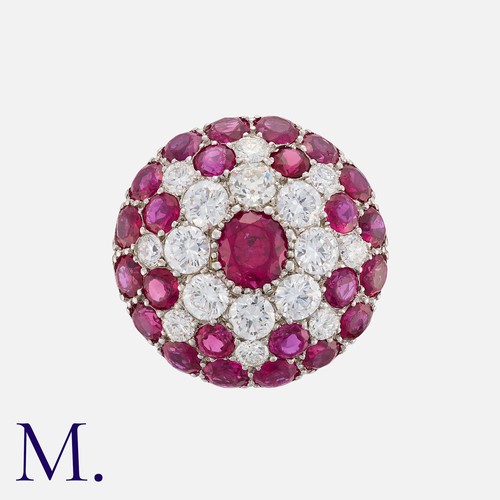 58 - A Ruby and Diamond Retro Cluster Ring in platinum in a bombé cluster arrangement.  Set with round cu... 