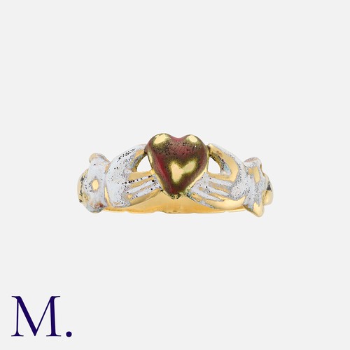 221 - An Enamel Claddagh Ring in yellow gold, designed as two hands clasped around a heart, decorated in w... 