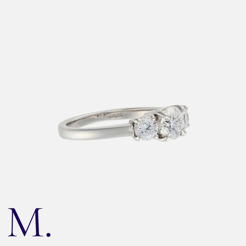 59 - A Diamond Three Stone Ring in platinum, comprising three round cut diamonds, the principal stone of ... 