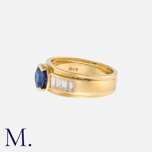 60 - A Sapphire And Diamond Ring in 18k yellow gold, set centrally with a round cut diamond of approximat... 