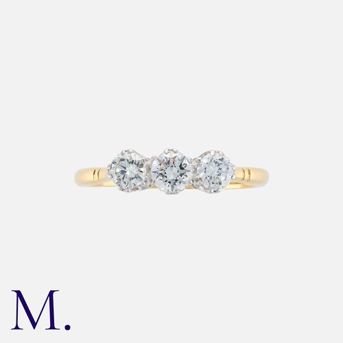 222 - A Diamond Three Stone Ring in 18k yellow gold, set with a trio of round cut diamonds totalling appro... 