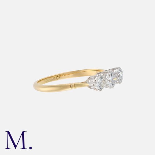 222 - A Diamond Three Stone Ring in 18k yellow gold, set with a trio of round cut diamonds totalling appro... 