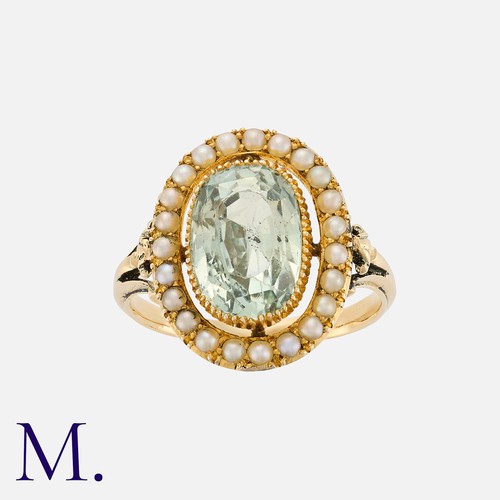 61 - An Aquamarine And Pearl Ring in yellow gold, comprising a principal oval cut aquamarine within a bor... 