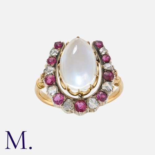 43 - A Moonstone, Ruby And Diamond Horseshoe Ring in yellow gold and silver, comprising a horseshoe motif... 