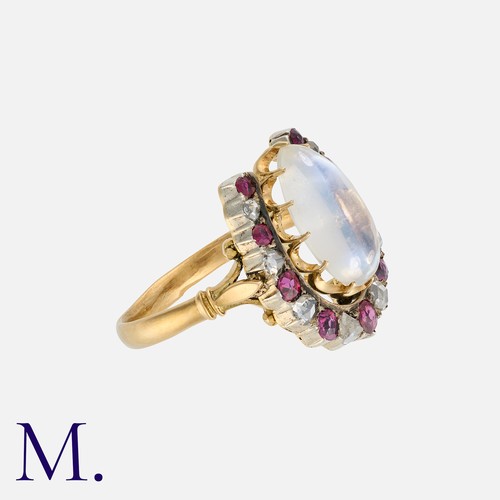 43 - A Moonstone, Ruby And Diamond Horseshoe Ring in yellow gold and silver, comprising a horseshoe motif... 