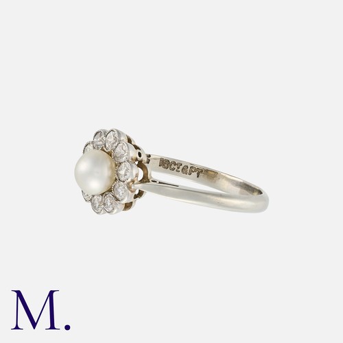 110 - A Pearl And Diamond Cluster Ring in 18k white gold and platinum, set with a central pearl of approxi... 