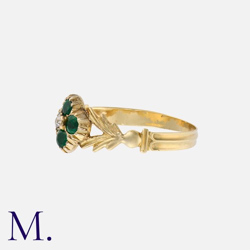 25 - An Emerald And Diamond Ring in yellow gold, set with four round cut emeralds in quatrefoil form, wit... 