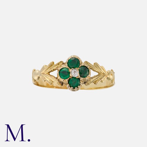 25 - An Emerald And Diamond Ring in yellow gold, set with four round cut emeralds in quatrefoil form, wit... 