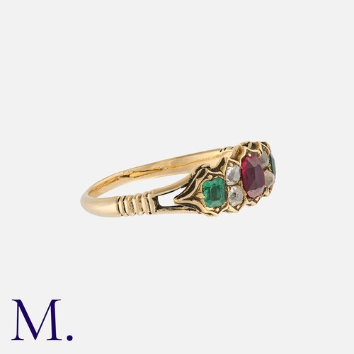 220 - A Ruby, Emerald And Paste Ring in yellow gold, set with a cushion cut ruby, flanked either side by p... 