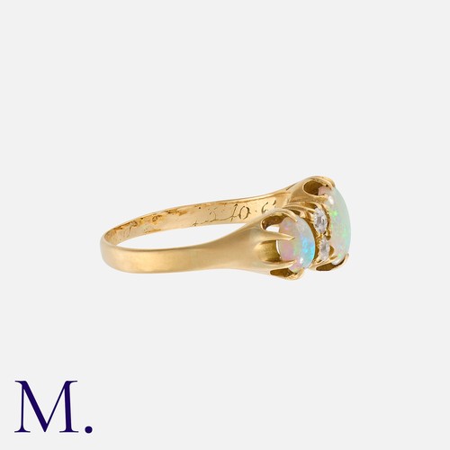 155 - An Opal And Diamond Ring in yellow gold, set with three cabochon opal, punctuated by pairs of old cu... 