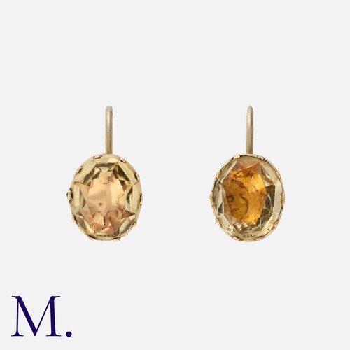 44 - A Pair Of Gemset Earrings in yellow gold and silver, each comprising an oval shaped yellow gemstone,... 