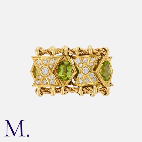 137 - A Peridot And Diamond Ring in yellow gold, in the manner of Elizabeth Gage, the articulated ring for... 