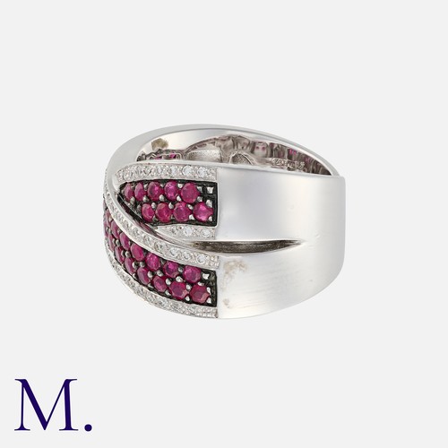 46 - A Ruby and Diamond Crossover Ring in white and black gold, set with round cut rubies to a black gold... 