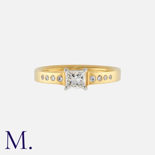 28 - A Diamond Solitaire Ring in 18K yellow and white gold, set with a princess cut diamond weighing 0.40... 