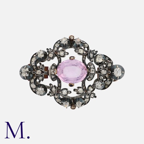 67 - An Antique Pink Topaz and Diamond Brooch in silver and gold, set with an oval cut pink topaz with ol... 