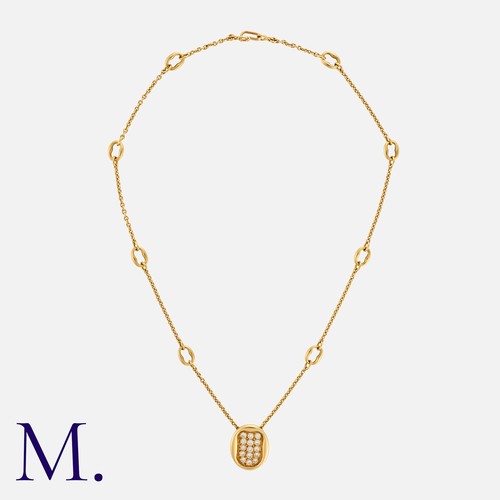 113 - CARTIER. A Diamond Pendant and Chain in 18K yellow gold, with oval pendant set with 15 round brillia... 