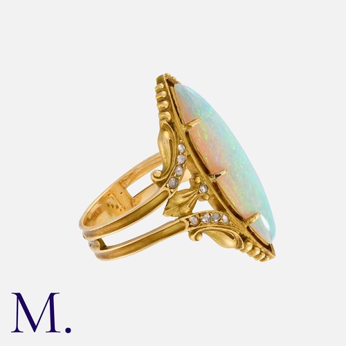 139 - An Art Nouveau Opal and Diamond Ring in 18K yellow gold, with a large marquise-shaped opal with exce... 