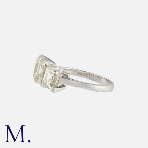 117 - An Asscher Cut Diamond Ring in 18K white gold, set with three asscher cut diamonds each weighing app... 