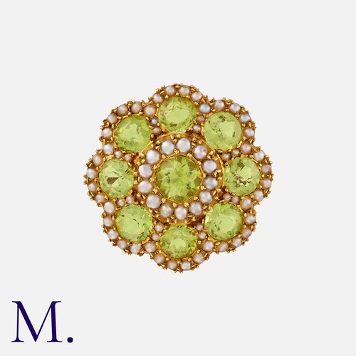 12 - A Peridot And Pearl Brooch in yellow gold, of floral form, comprising a cluster of round cut peridot... 