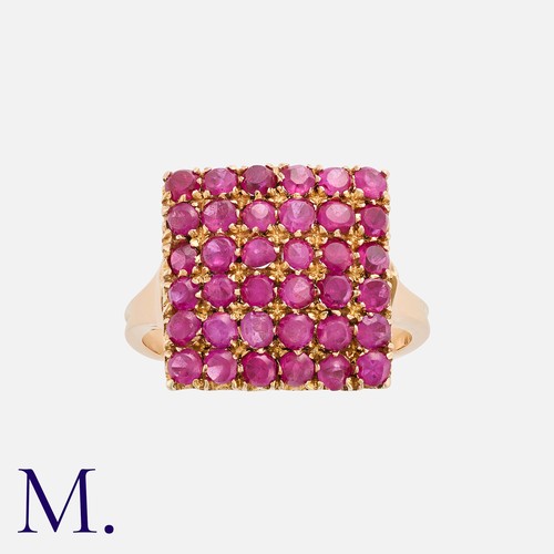 90 - A Ruby Ring in yellow gold, of square form, set with six rows of round cut rubies. Mark indistinct b... 