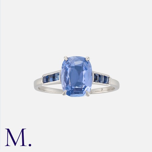 32 - A Sapphire Ring in platinum, set with a cushion shaped sapphire of approximately 1.86cts, accented e... 