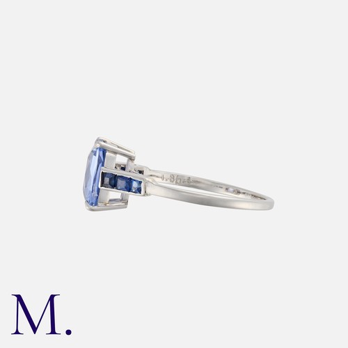 32 - A Sapphire Ring in platinum, set with a cushion shaped sapphire of approximately 1.86cts, accented e... 