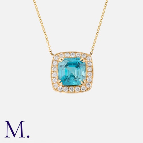 144 - A Zircon And Diamond Pendant Necklace in 18k yellow gold, set with an octagonal cut blue zircon with... 