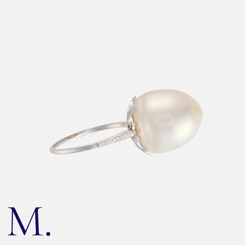 13 - A Pearl Ring in platinum, set with a large untested pearl of approximately 15mm X 12mm. Unmarked but... 