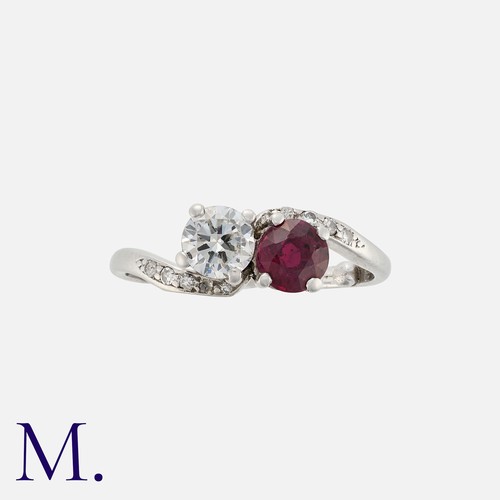 14 - A Ruby and Diamond Toi et Moi Ring in platinum, set with a round cut diamond weighing approx. 0.60ct... 