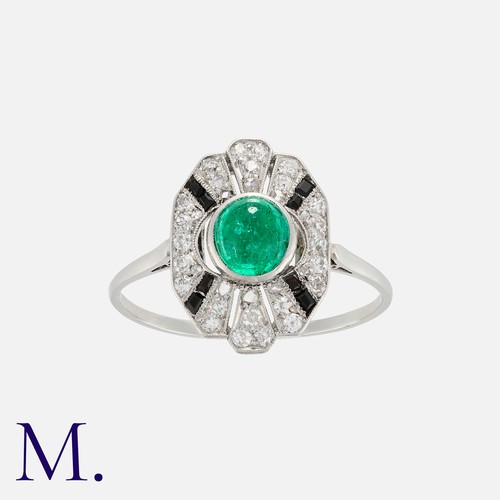 153 - An Emerald, Onyx and Diamond Ring in white gold, set with a cabochon emerald to the centre with cali... 