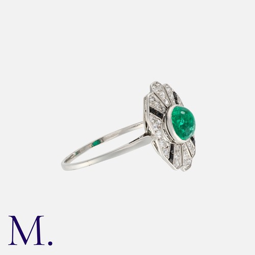 153 - An Emerald, Onyx and Diamond Ring in white gold, set with a cabochon emerald to the centre with cali... 