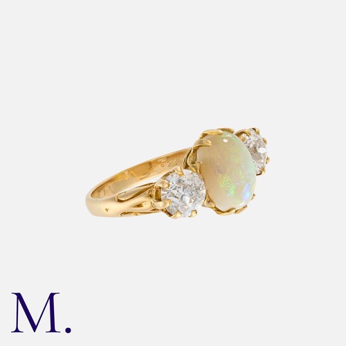 164 - An Antique Opal and Diamond Ring in 18K yellow gold, set with an oval cabochon opal to the centre wi... 