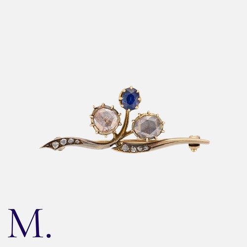 33 - A Rose Cut Diamond And Sapphire Brooch in yellow gold, of foliate design, set with two large rose cu... 