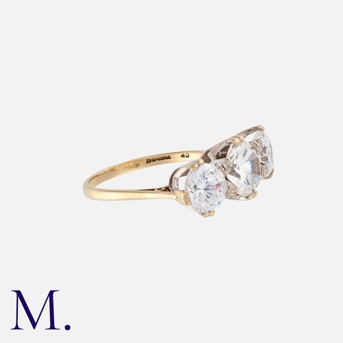 13 - A Three Stone Ring in 9k yellow gold, set with three large round cut cubic zirconia. Stamped 375 for... 